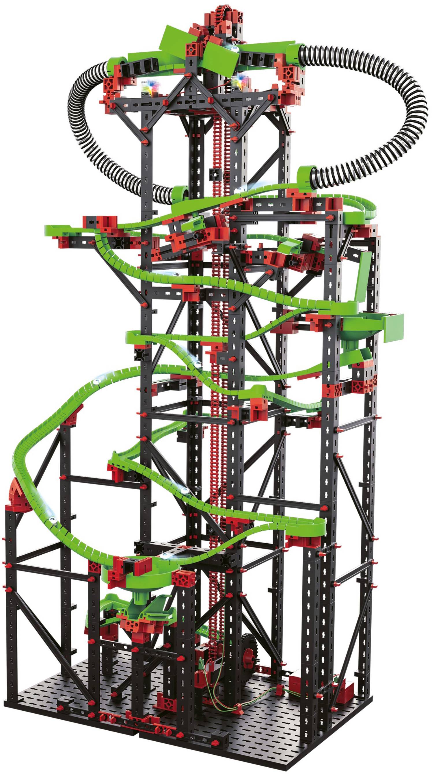 A tall tower made of colourful building blocks with a green slide winding around the structure, supported by black struts.
