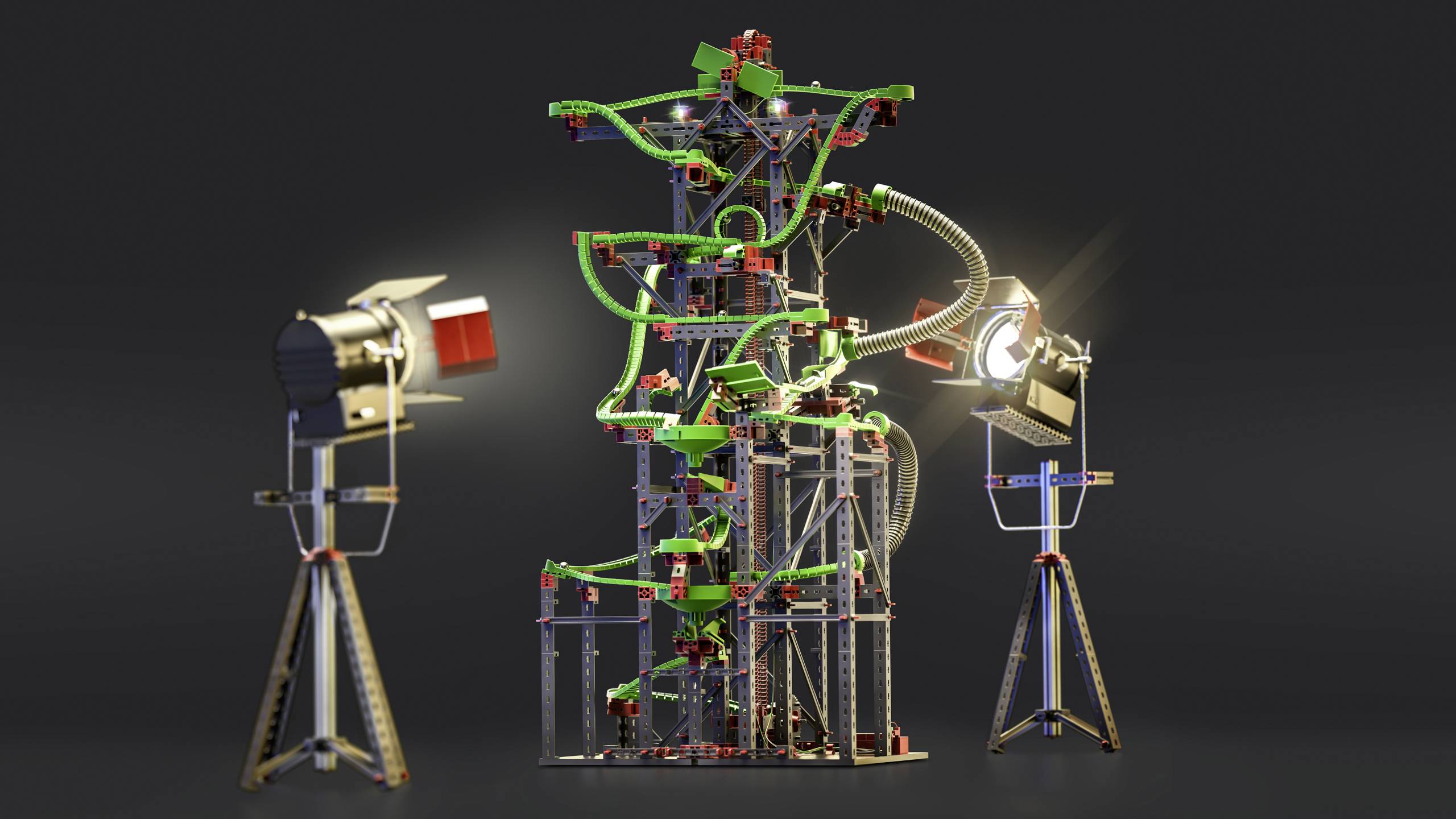 'Complex marble run with green and red building blocks, illuminated by two studio lights, shows an intricate structure.'
