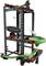 Marble run construction kit with black struts, green rails, and a rotating disc for guiding marbles.