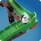 Section of a marble run with a green zigzag path, along which a metal ball is rolling. Structure made of red and black building blocks.