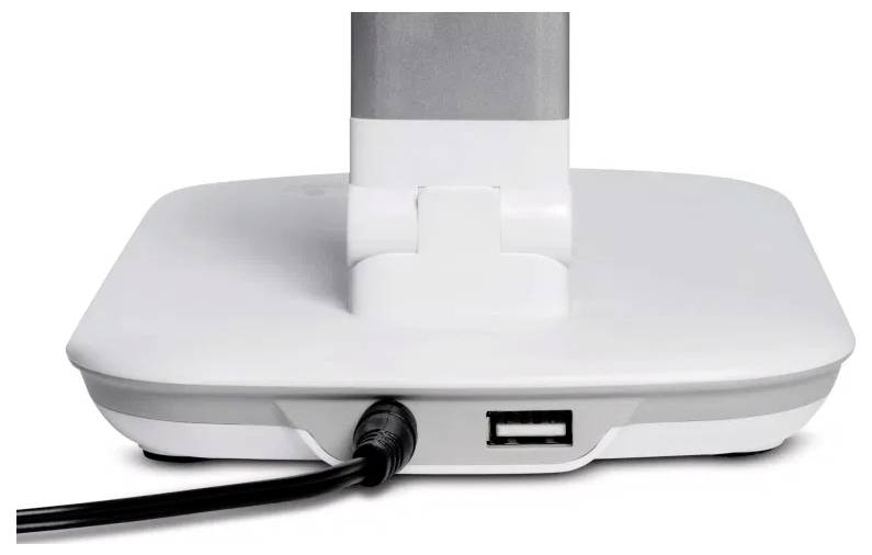 Base of a white monitor stand with an attached power cord and a USB port on the back side.