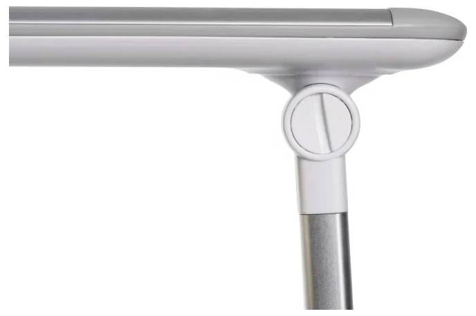A close-up of an adjustable desk leg with a height adjustment knob, viewed from the side. The desk surface is light gray.