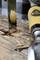 Woodworking: Close-up of a chisel penetrating a piece of wood. Wood shavings and sharp blade are visible.