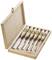 An open wooden box containing six wood carving tools. Each tool has a wooden handle and is neatly positioned in its designated slot.
