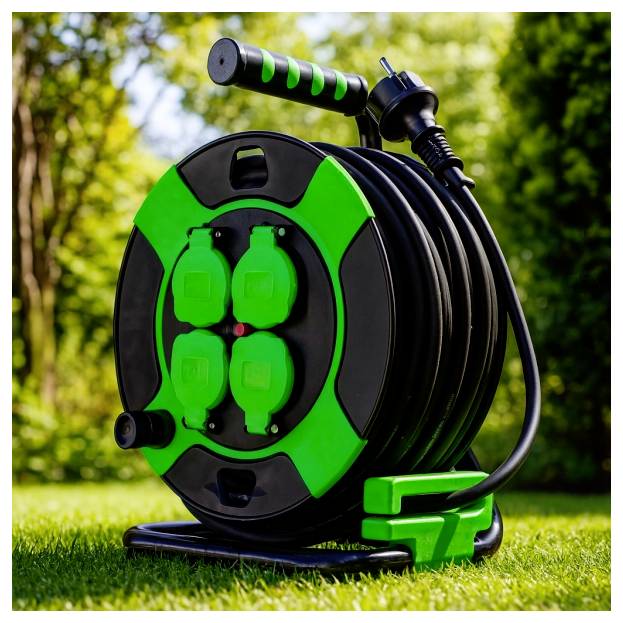 'A green and black extension cord reel with multiple outlets, situated on a lawn with blurred trees in the background.'