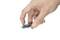 A hand is holding a USB stick between thumb and forefinger. The stick is black with a blue end.