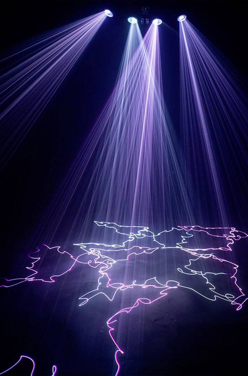 Stage with purple and blue lights casting rays onto the floor, and illuminated outlines of a world map.