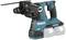 A cordless drill hammer in blue with two batteries, used for construction or renovation work. Makita logo visible.
