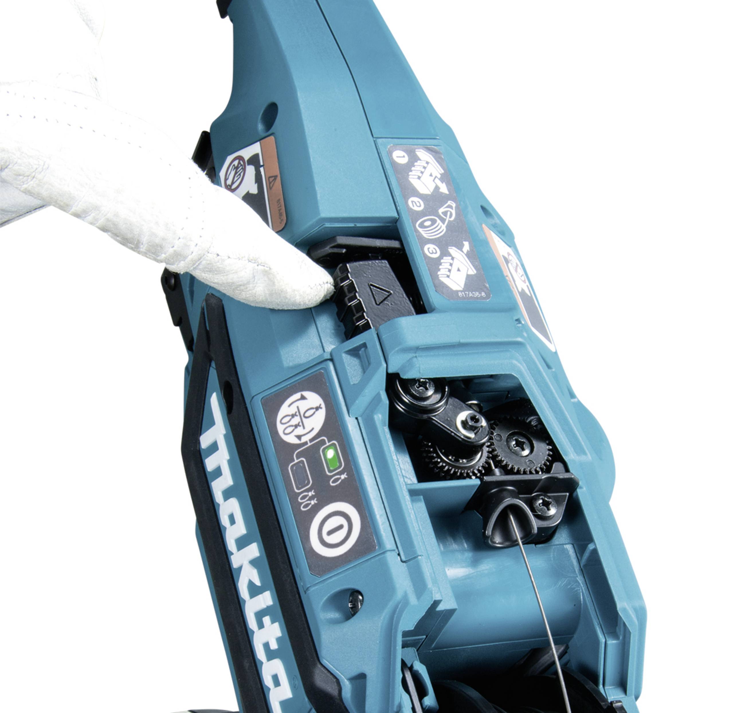 A person wearing a white glove is operating a blue, portable tape cutter. The close-up shows the adjustment area of the device.