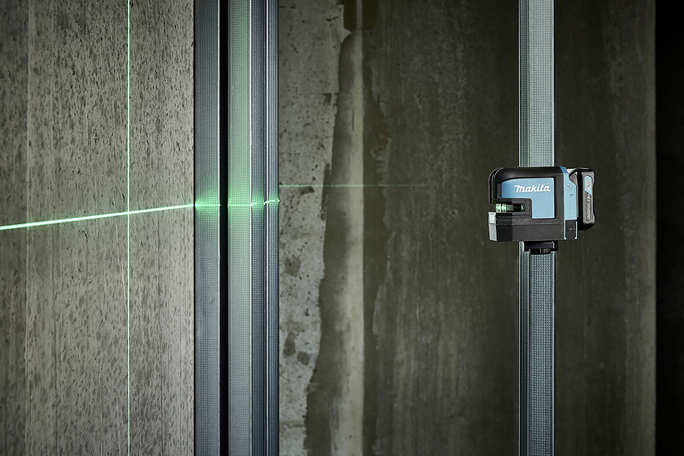 'Green laser level projects line onto wall for measurement and alignment in construction.'