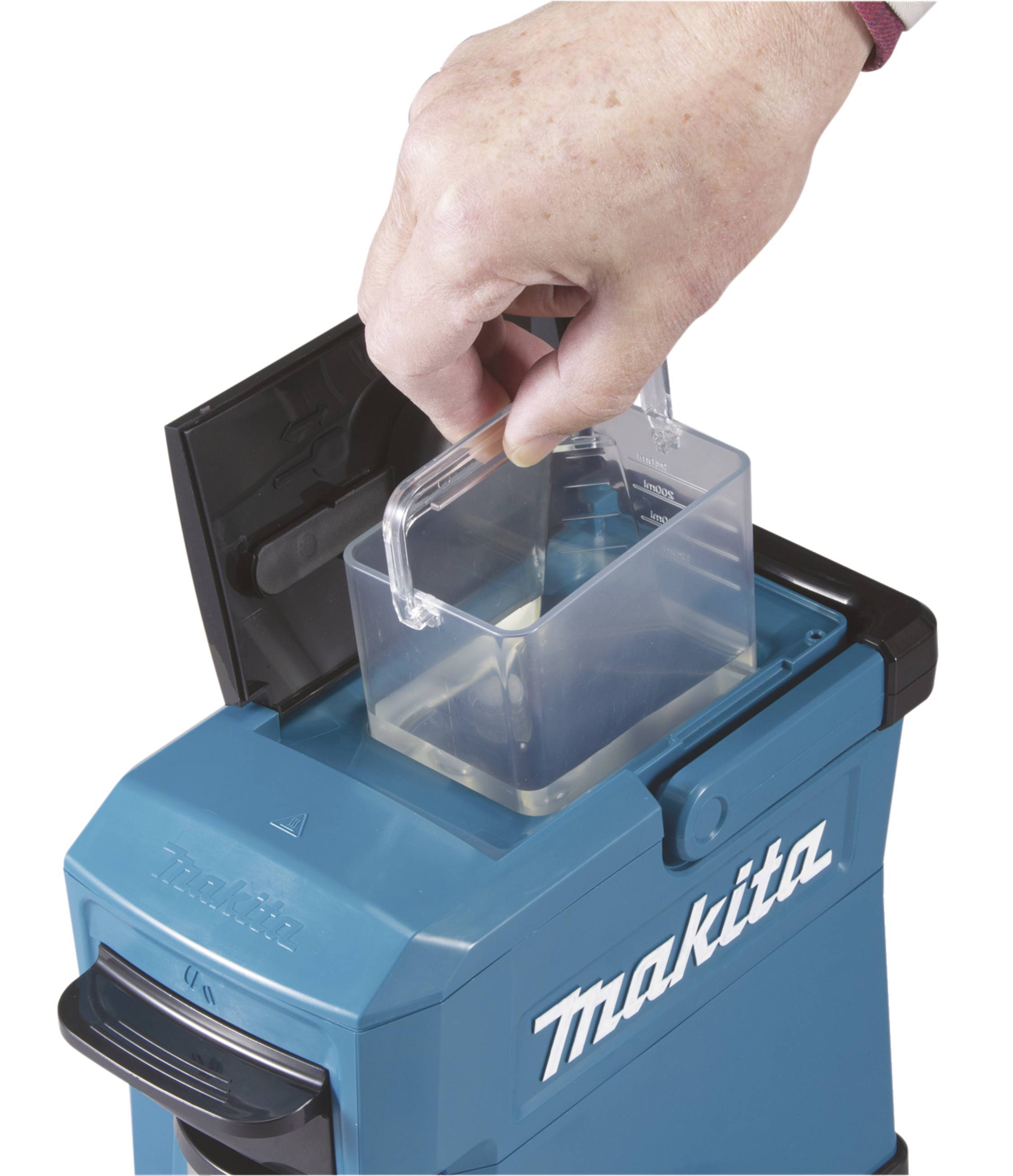 Hand removes dust container from a blue Makita vacuum cleaner.