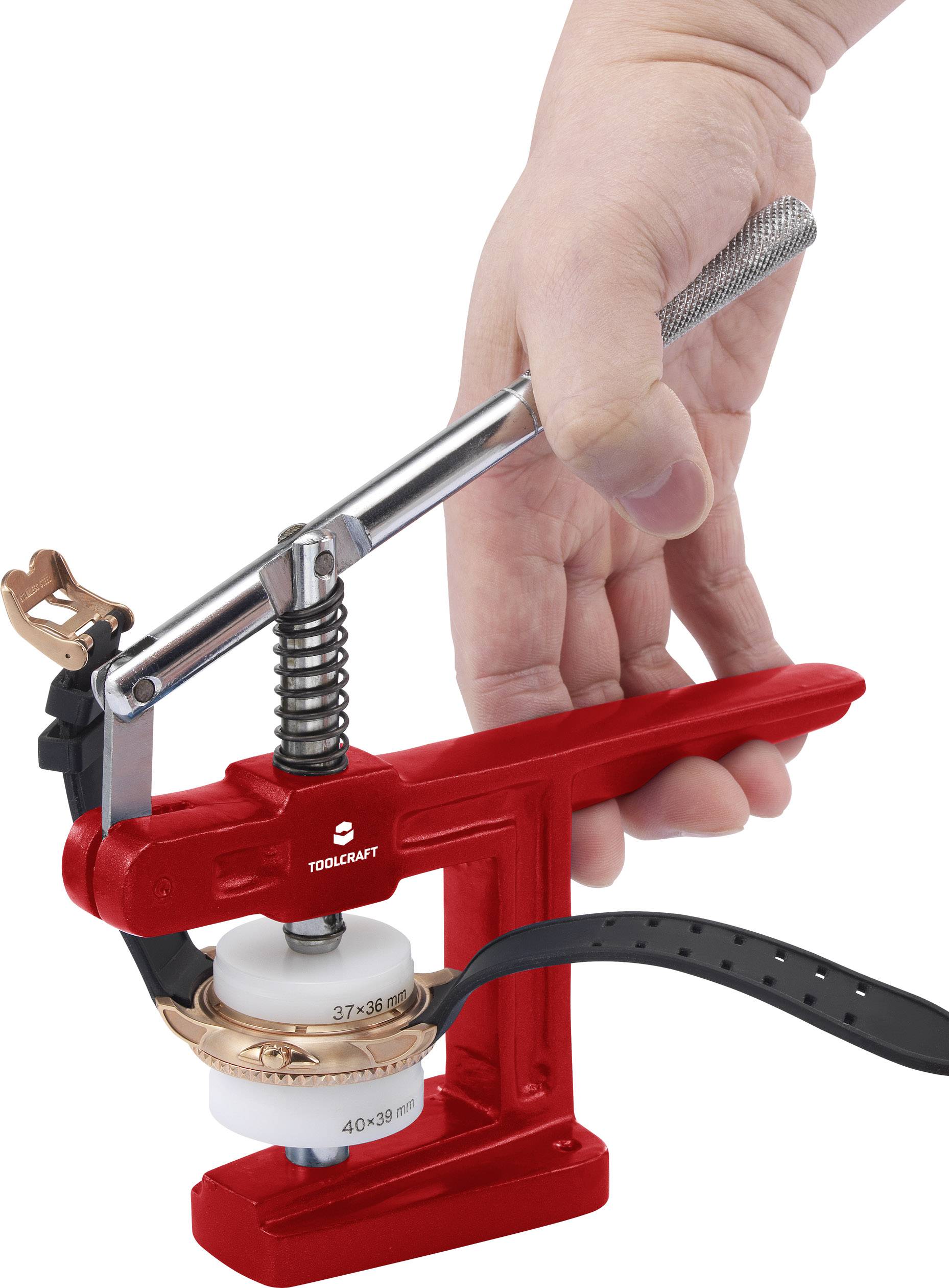'Tool for watch repair with red lever. A hand presses the lever to fasten or release a watch strap.'