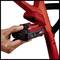 A hand is inserting a red battery into an electrical tool.