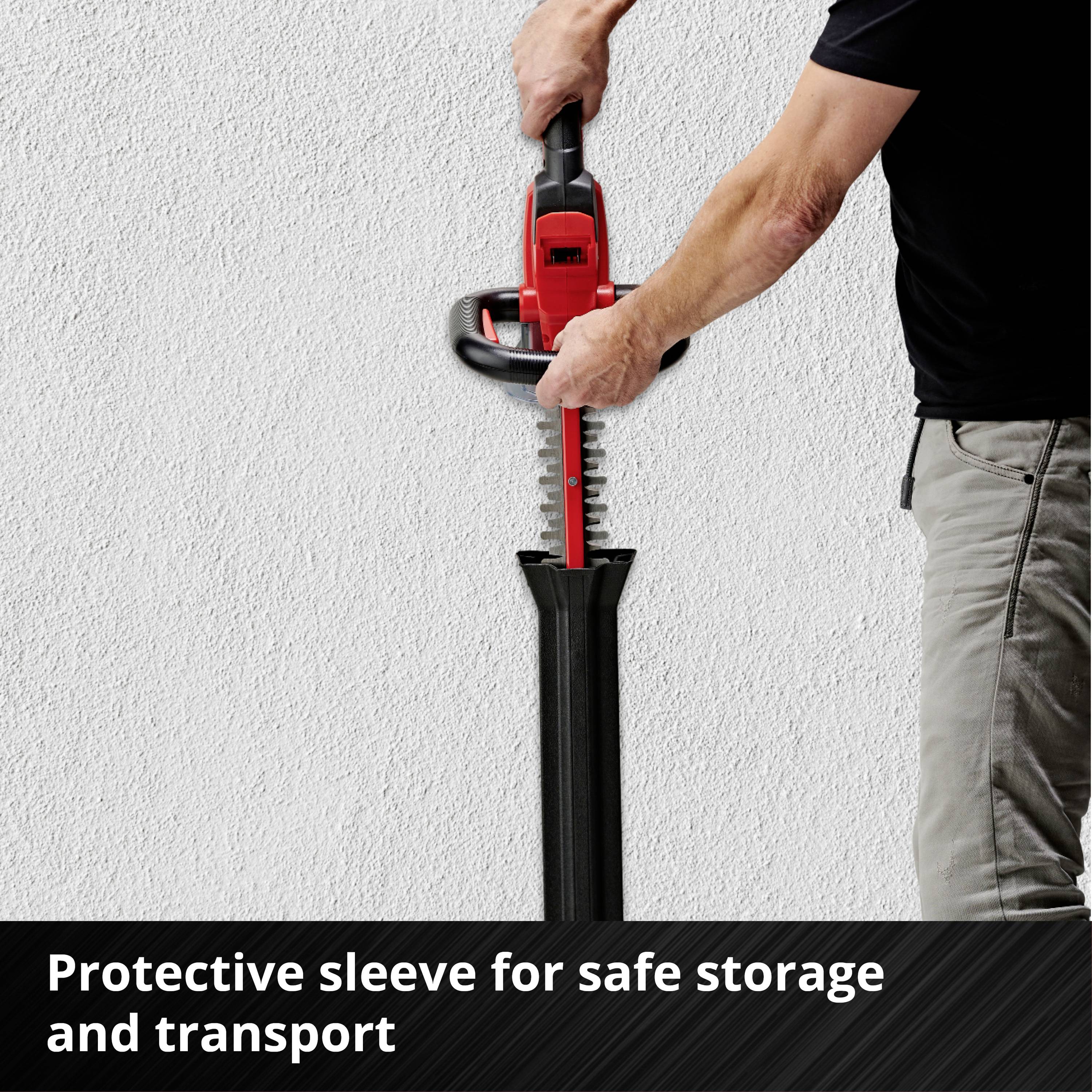 A man holds a red hedge trimmer against a white wall. Text below: 'Protective sheath for safe storage and transport'.
