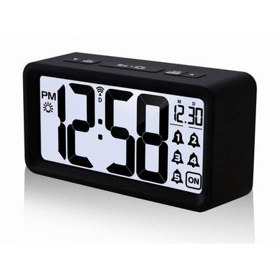 A digital alarm clock displays the time as 12:58 PM. To the right is the date 30.12. The alarm clock has a slim, black design.