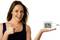 A woman is holding a digital thermo-hygrometer in her hand, which displays 12:34, 59% humidity, and 26.5°C.
