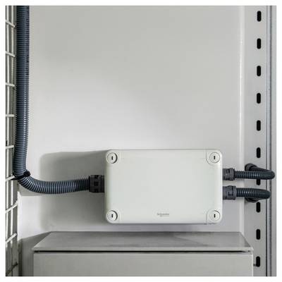 A wall-mounted white electrical junction box with conduit pipes and cables on both sides inside a utility cabinet.