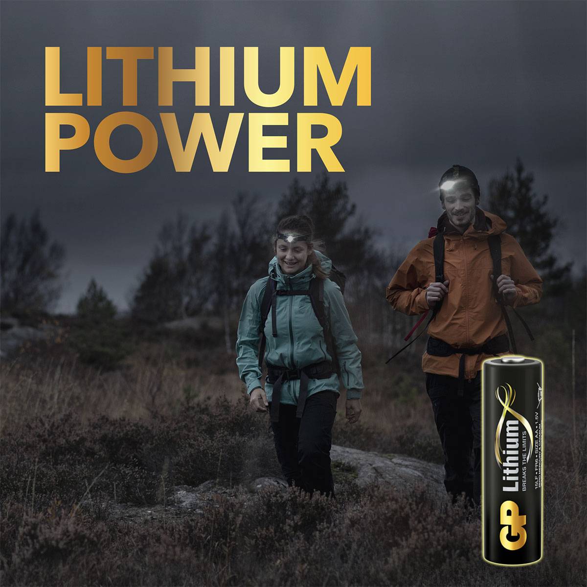 Two people are hiking with rucksacks through a rugged landscape. 'LITHIUM POWER' is written at the top; a battery is depicted in the bottom right corner.