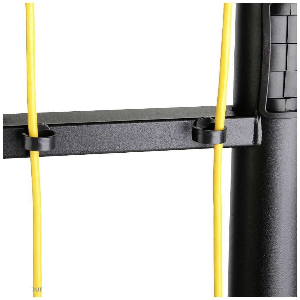 Close-up of a black plastic device with yellow cables routed through mounting clips.