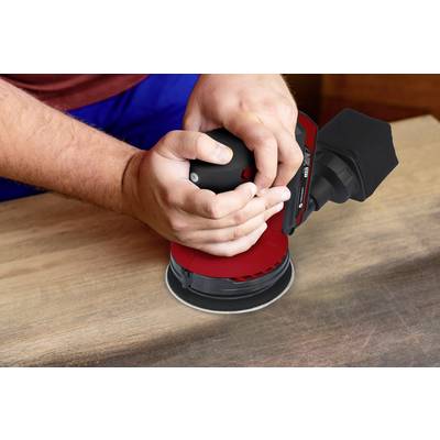 A person is sanding a wooden surface with an electric sanding device. The device has a red cover.