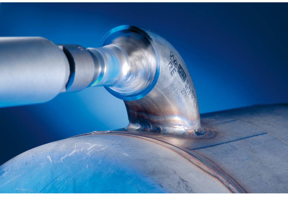 A pipe is welded with a rotating tool. The focus is on the precision and technique of the weld.