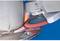 An angle grinder is grinding a metal weld. Sparks are flying. The work is being carried out on a circular metallic workpiece.