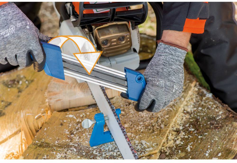 A person is sharpening the chain of a chainsaw with a file. Protective clothing such as gloves is being worn.