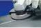 A grinding machine is used to smooth the surface of a metal. The user is wearing safety gloves.