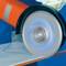 A circular saw cuts through a thin metal layer. The movement of the circular saw is visible as it processes the material.