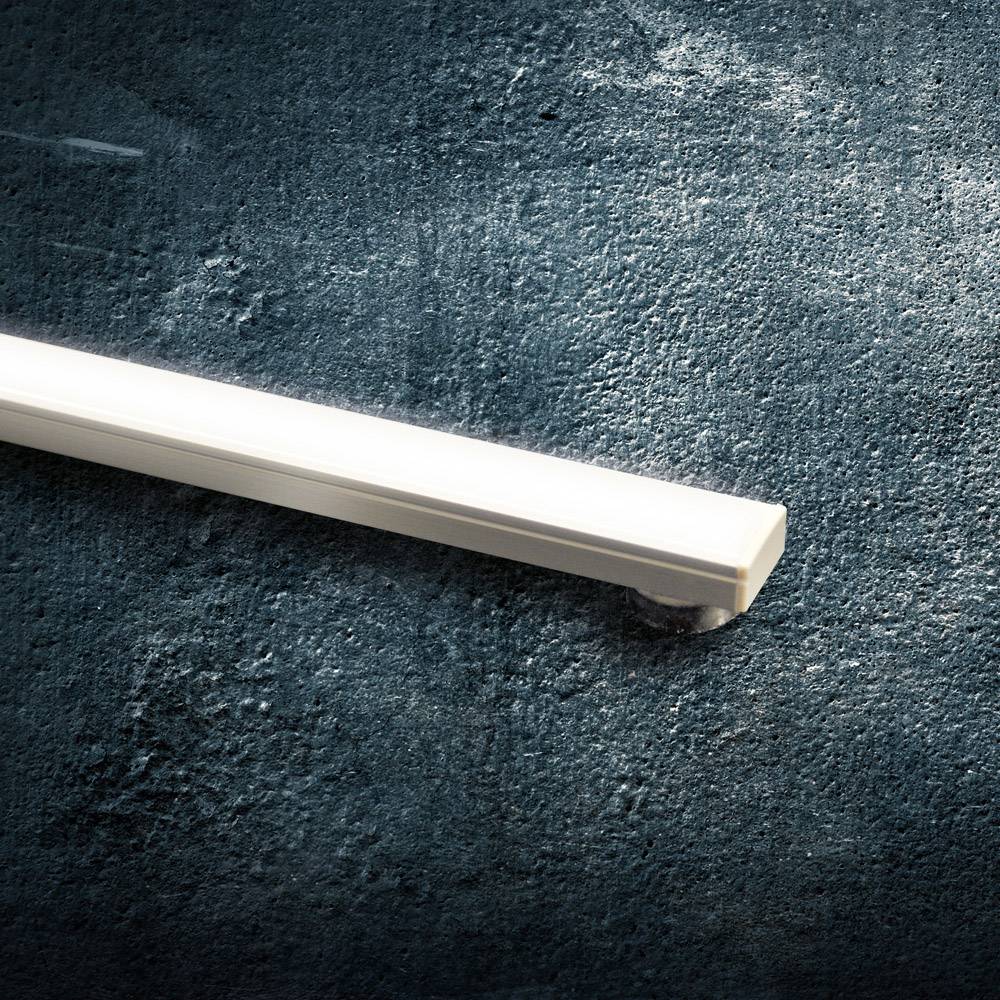 A long, white LED strip on a dark background. It glows brightly and stands out clearly against the background.