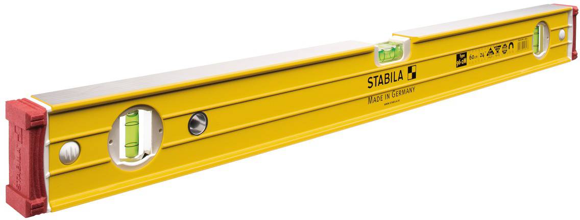 Spirit level made of yellow metal with horizontal and vertical vials for measuring flatness and inclination.