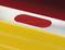 A close-up of a yellow and red object with an oval red area within a silver stripe.