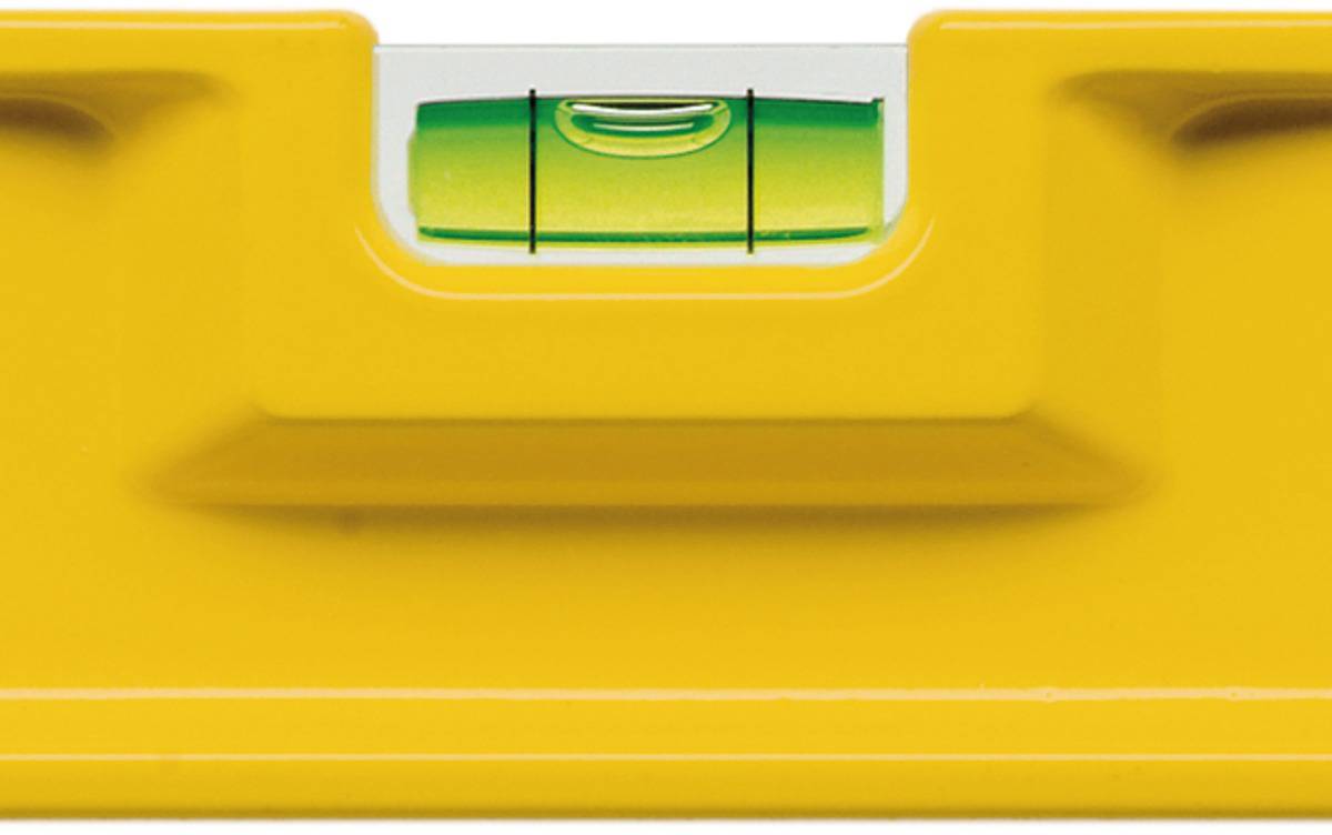 Yellow spirit level with green bubble vial in the centre, bubble centred between the markings, indicating a horizontal plane.