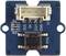 A blue module card close-up reveals a central push button, several resistors, and a plug connection with labels such as VCC and GND.