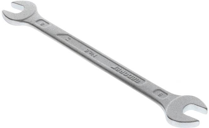 A silver double-ended spanner with sizes 13 and 15, made of metal, lies on a white background.