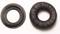 Two black ear cushions, one compressed and the other in its normal round shape, on a white background.