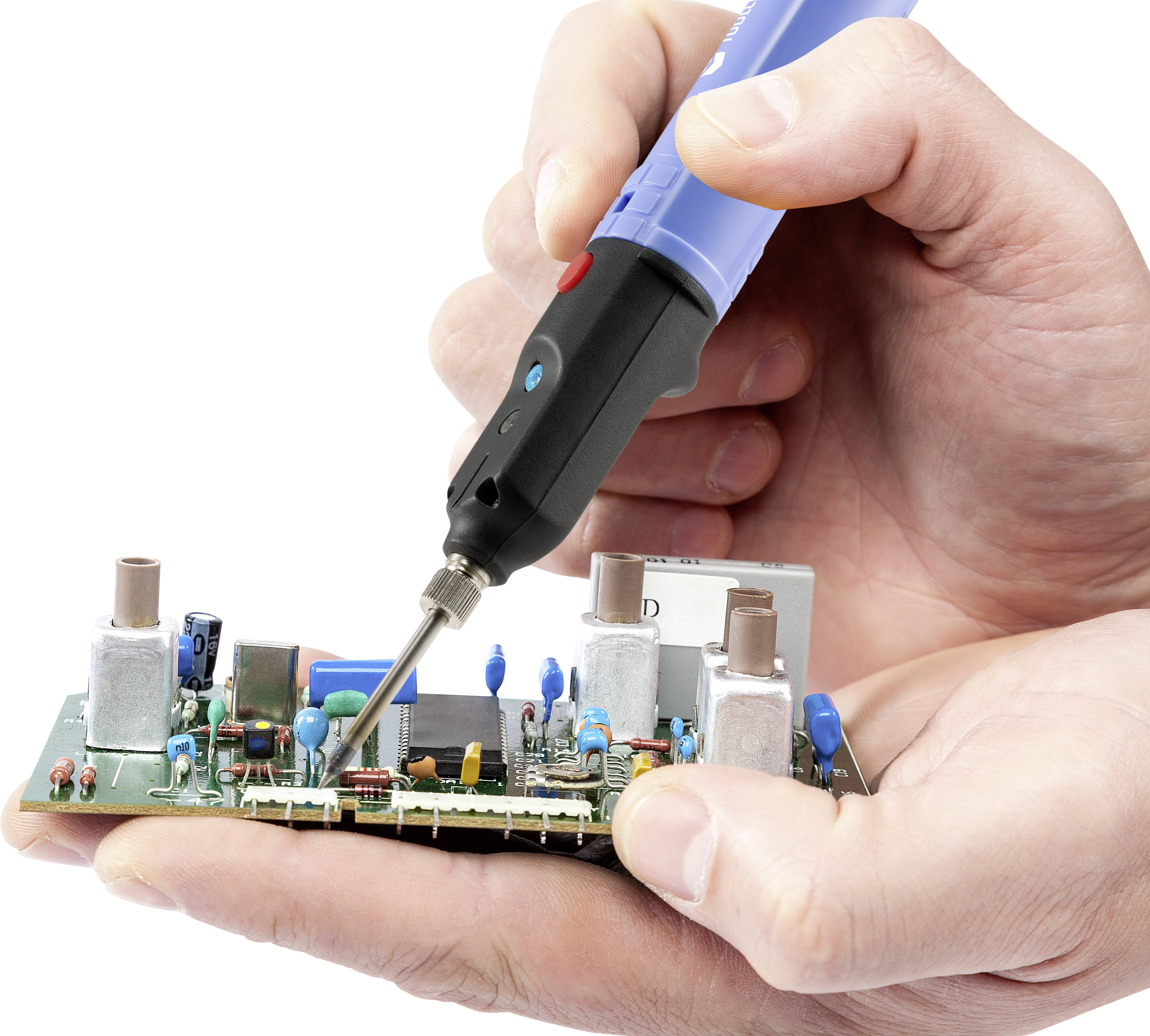 A hand solders components onto a circuit board using a soldering iron. The focus is on precise technical work with electronic components.