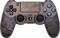 A PlayStation controller with a rusty metal design. The buttons are clearly visible and arranged in the typical PlayStation layout.
