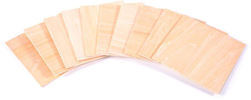 Four rectangular wooden boards lie half-overlapping on a surface, displaying a natural wood grain.
