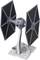 A grey model of a TIE Fighter from a science fiction film series, displayed on a stand, shows a detailed structure.