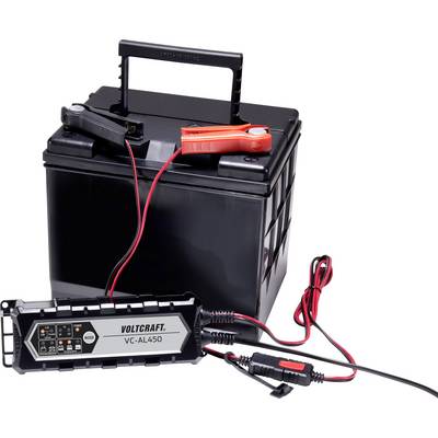 Black car battery with a connected battery charger. Red and black cables connect terminals to the charging device.
