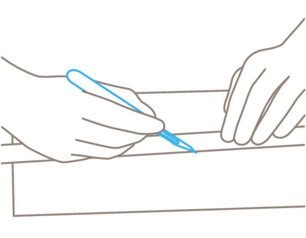 Two hands work together: one holds a ruler, the other marks a line with a blue pen on a sheet of paper.