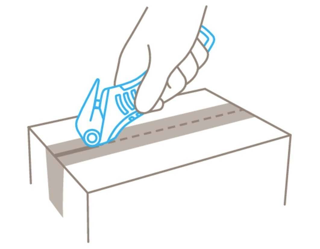 A hand is using a safety knife to cut a line along the top of a cardboard box.