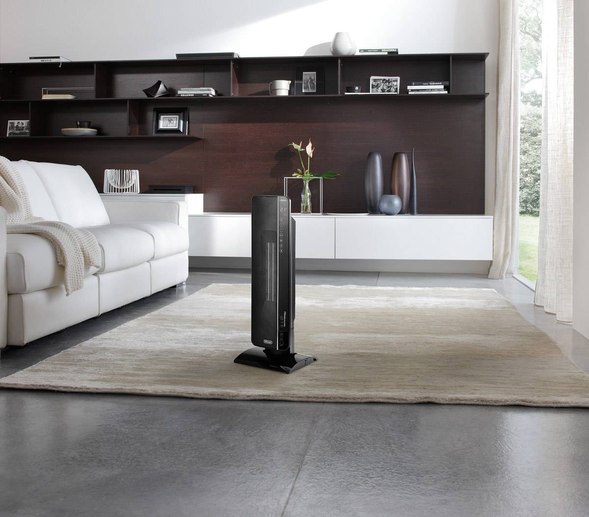 An elegant room with a modern wood burner on carpet, surrounded by minimalist furniture and expansive windows.