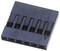 A black plastic connector cover with six terminals, rectangular in shape, lying in the foreground.