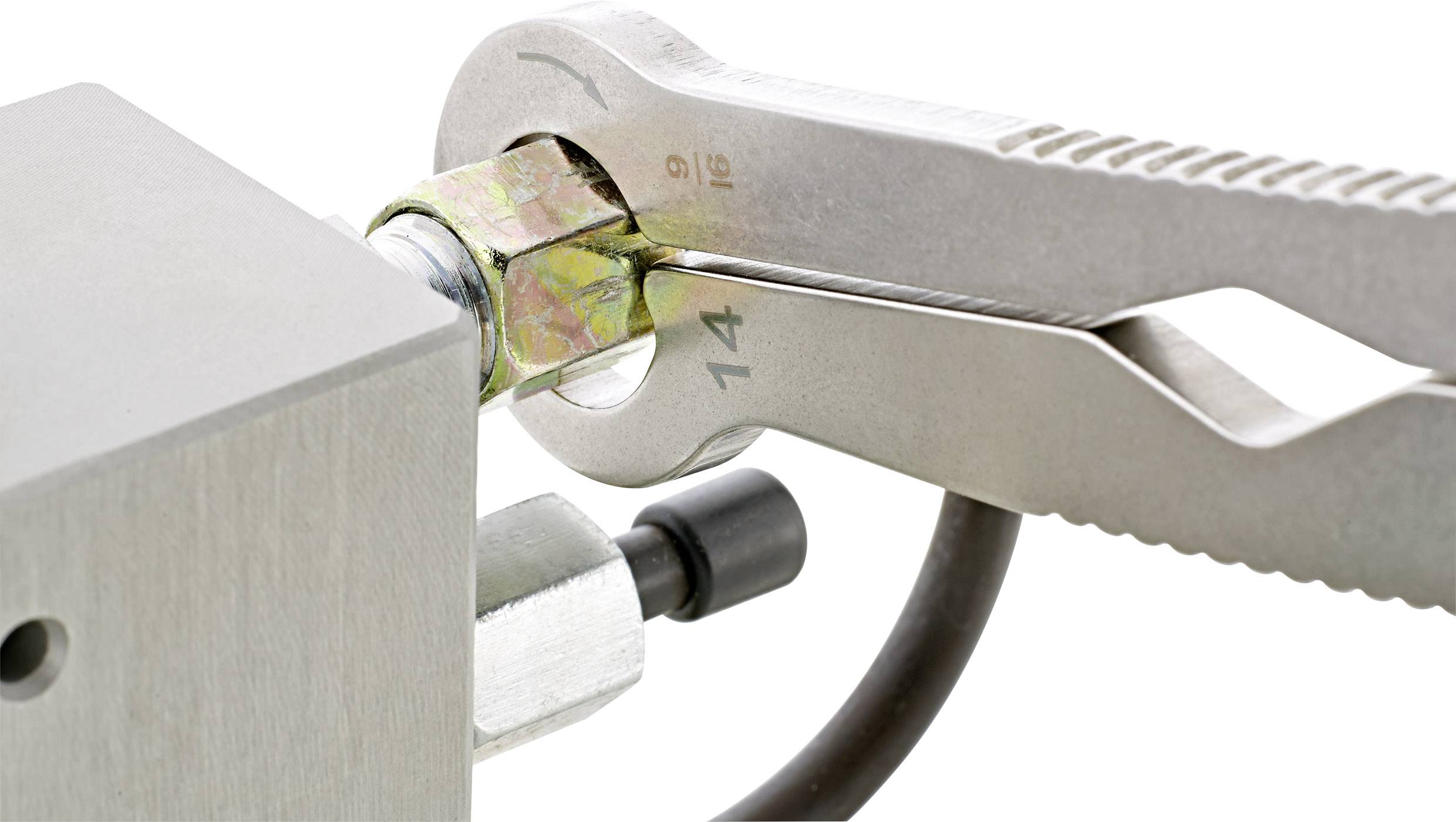 'Close-up of a size 14 spanner tightening a nut on a metal device.'