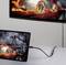 A tablet displays an image of a car with flame effects. It is connected to a larger screen via a cable, which shows the same image.