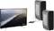A television displays a coastal landscape. Two computers are connected via cables through an adapter, which is also connected to the television.