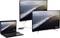 A laptop displays a coastal landscape, connected to two large monitors showing the same scene.