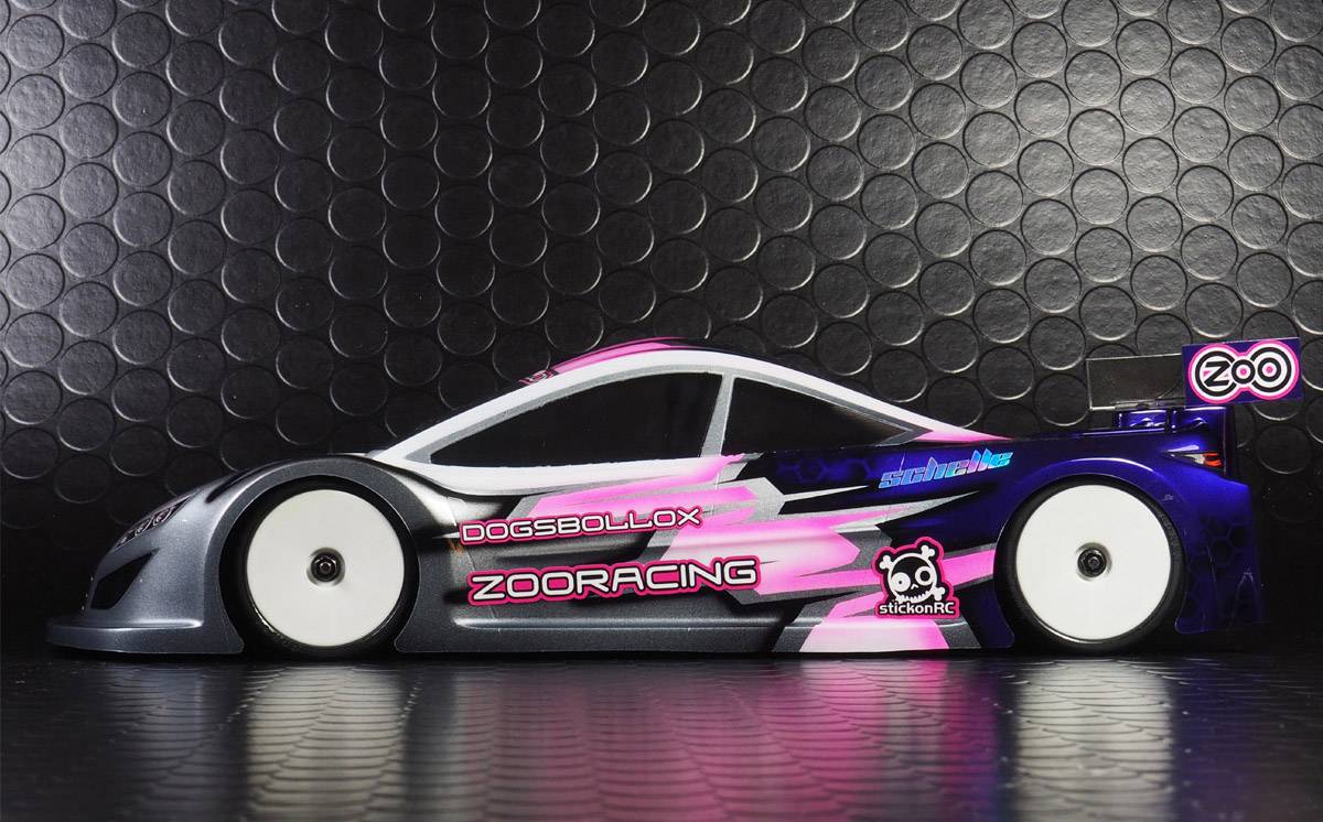 A remote-controlled car with a striking pink, white, and black design and brand logos on a glossy black background.
